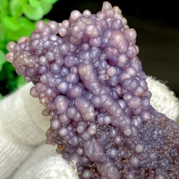 Tall cluster of purple grape agate balls from Indonesia, close-up of the crystal faces