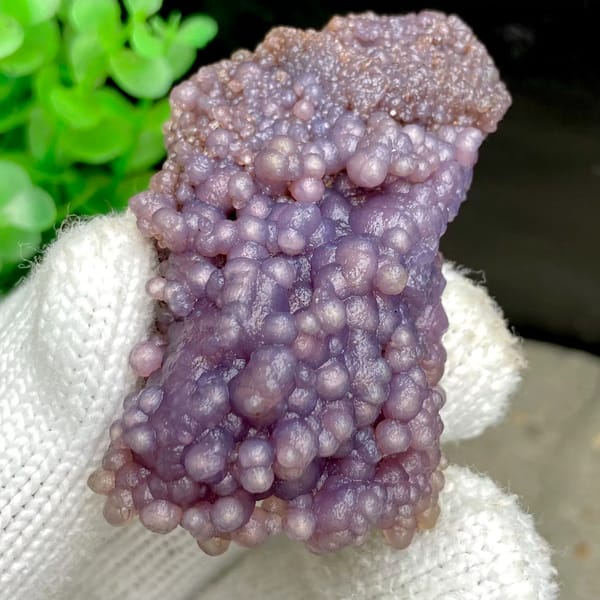 Tall cluster of purple grape agate balls from Indonesia, detail of the matrix contact