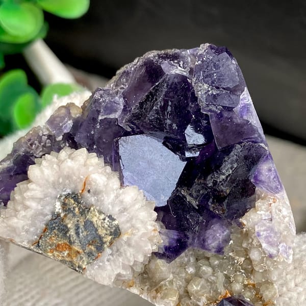 Deep purple fluorite cubes above white bladed calcite from Fujian, China, reverse side