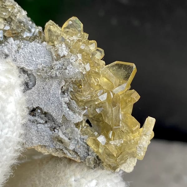 Golden transparent baryte blades on grey matrix from Yunnan, China, top view
