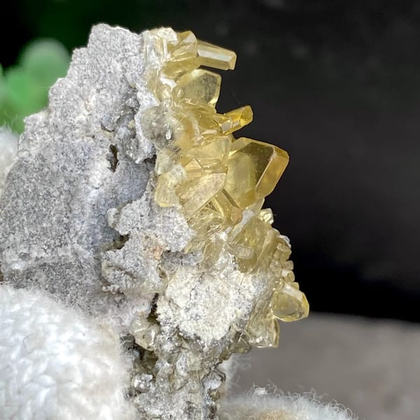 Golden transparent baryte blades on grey matrix from Yunnan, China, close-up of terminations