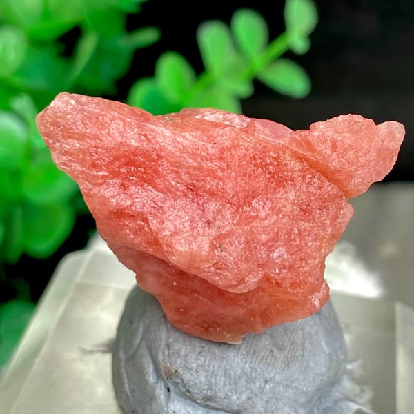 Salmon-pink rhodochrosite nugget from Wuzhou, Guangxi, China, detail of the matrix contact