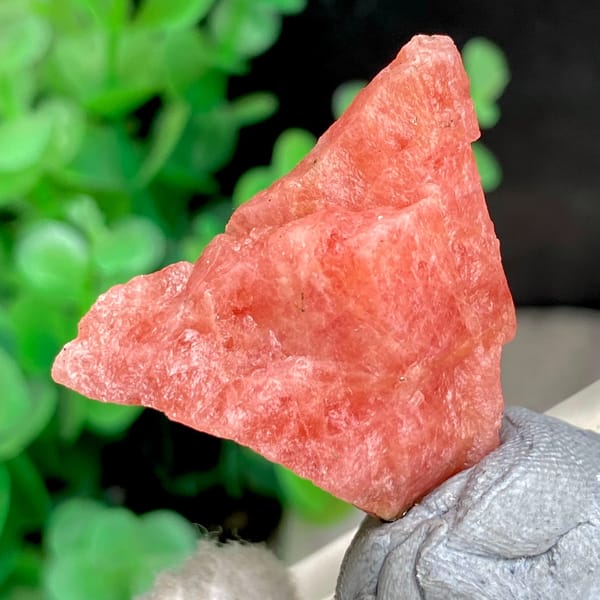 Salmon-pink rhodochrosite nugget from Wuzhou, Guangxi, China, side view