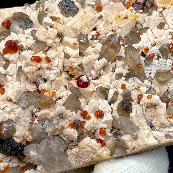 Bar of feldspar dotted with Fanta-orange spessartine and smoky quartz from Yunxiao, Fujian, China, reverse side
