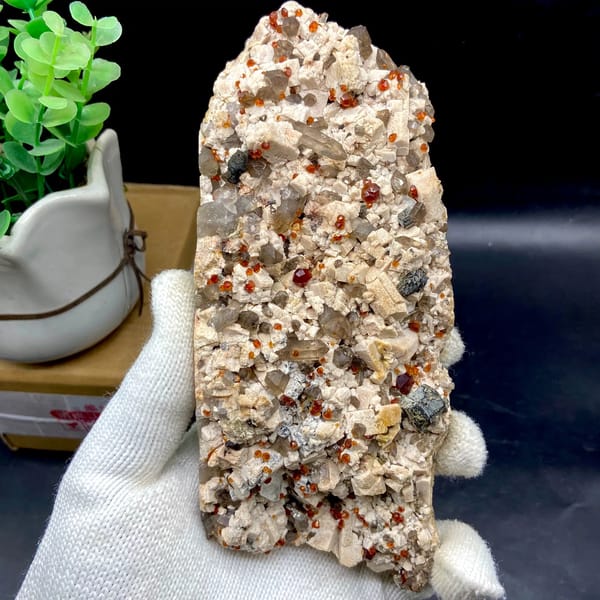Bar of feldspar dotted with Fanta-orange spessartine and smoky quartz from Yunxiao, Fujian, China, overall view