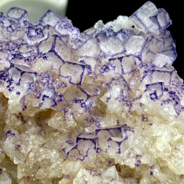 Guizhou fluorite plate with pale cubes outlined in deep purple — detail view