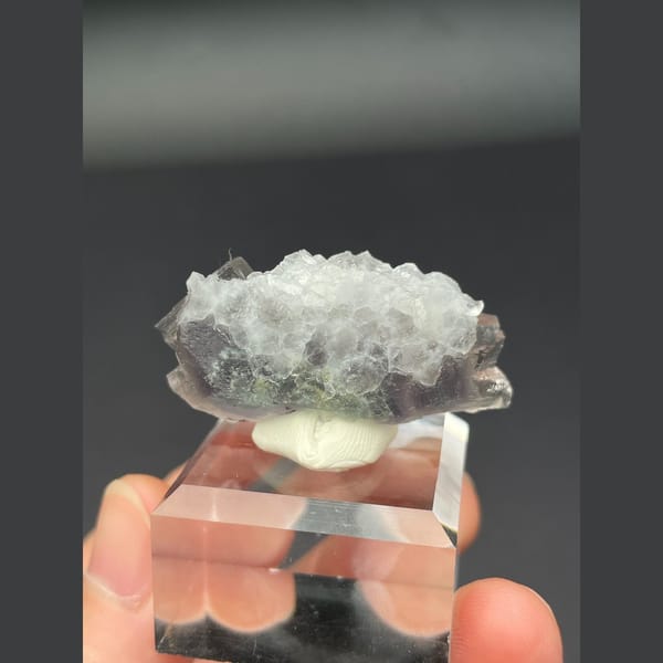 Translucent pale fluorite with frosted top and blue heart from Zhejiang — detail view