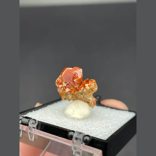 Small cluster of glossy red-orange vanadinite crystals from Morocco — detail view