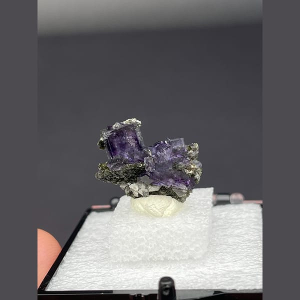 Deep purple fluorite cubes on dark matrix from Yaogangxian, Hunan — complete view