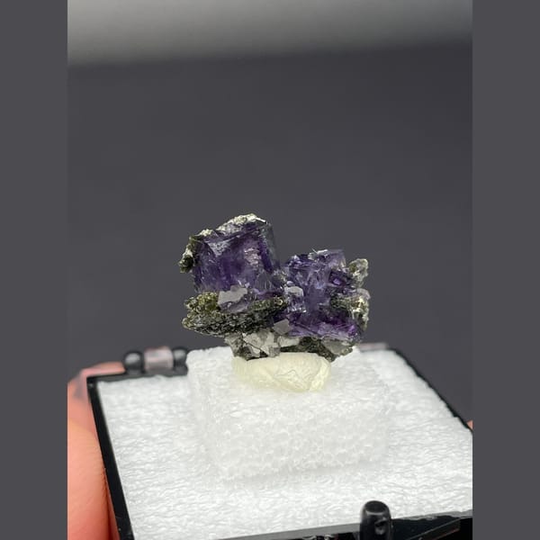 Deep purple fluorite cubes on dark matrix from Yaogangxian, Hunan — alternate view