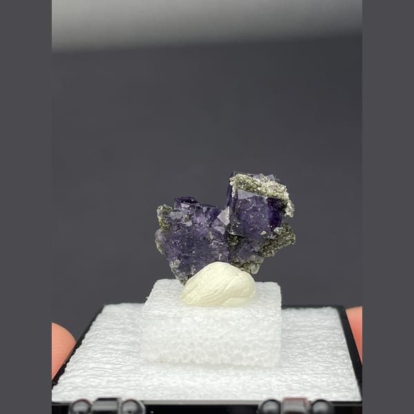 Deep purple fluorite cubes on dark matrix from Yaogangxian, Hunan — alternate view