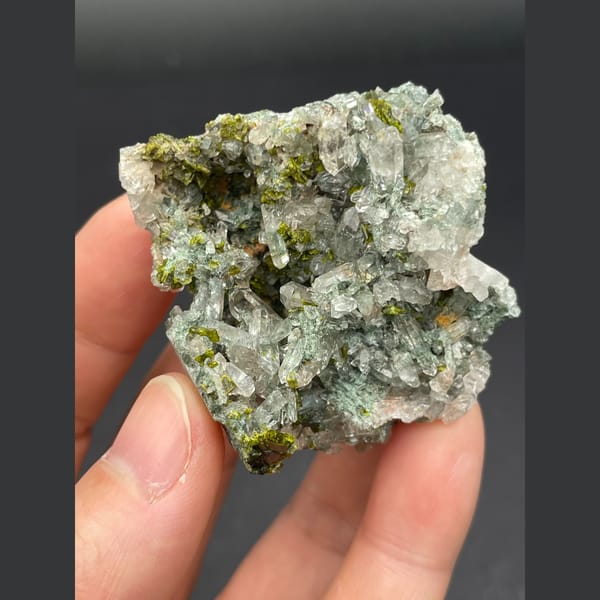 Glassy green phantom quartz with dark green epidote from Meigu, Sichuan — detail view