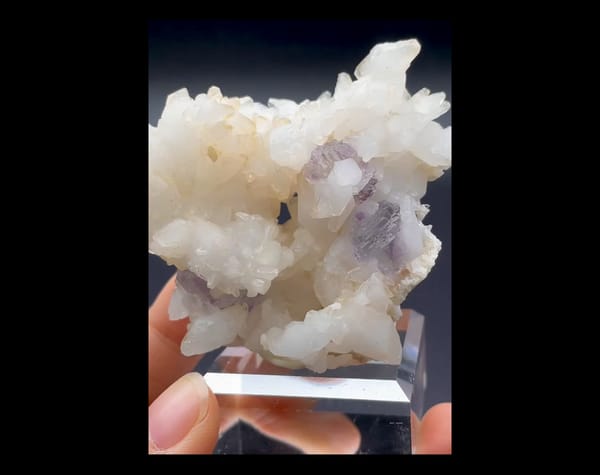Complete front-oblique view of lavender phantom fluorite with calcite and pyrite from Shangbao