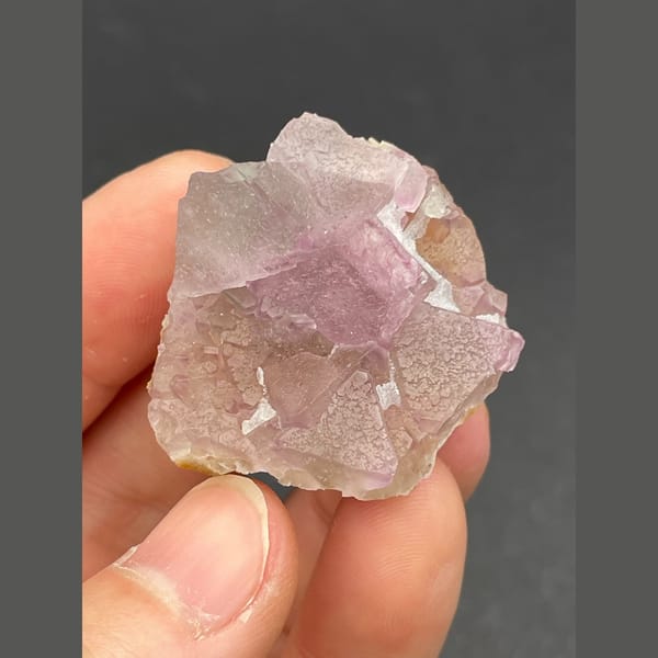 Pale lavender-pink cubic fluorite cluster from Zhejiang — complete view
