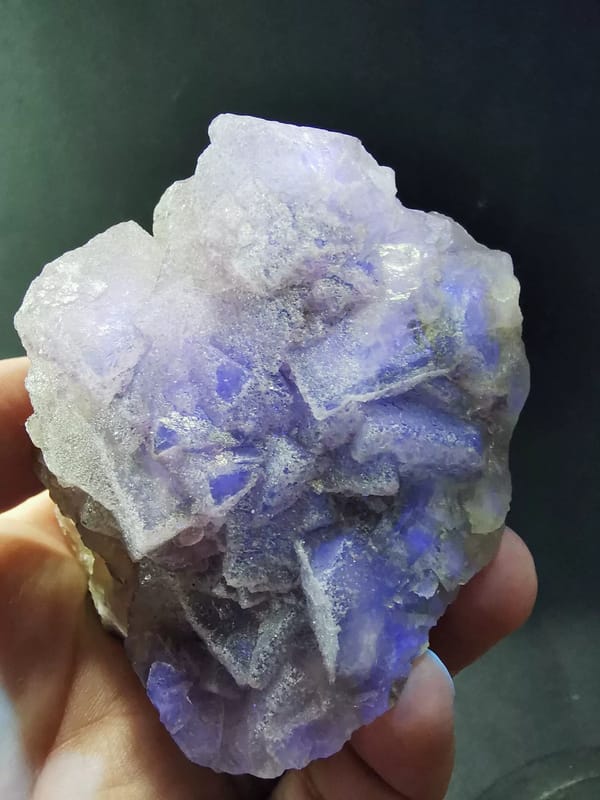 Pale yellow-violet fluorite on candle quartz — complete light-shifted front view of the exact specimen