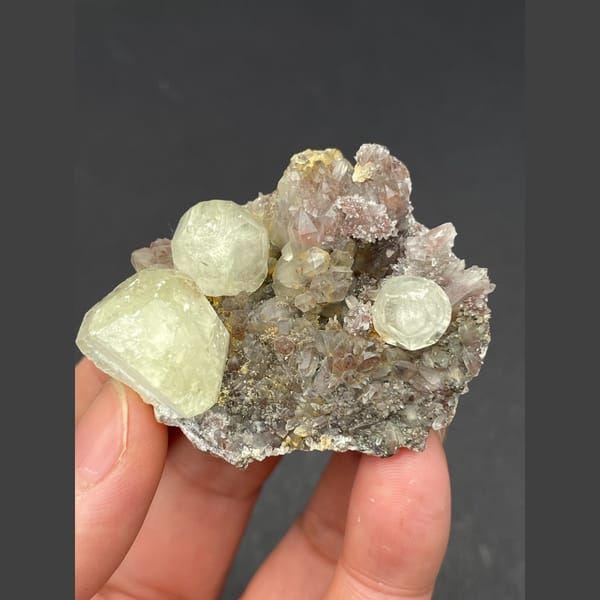 Pale yellow calcite balls on sparkly quartz from Hubei — complete view