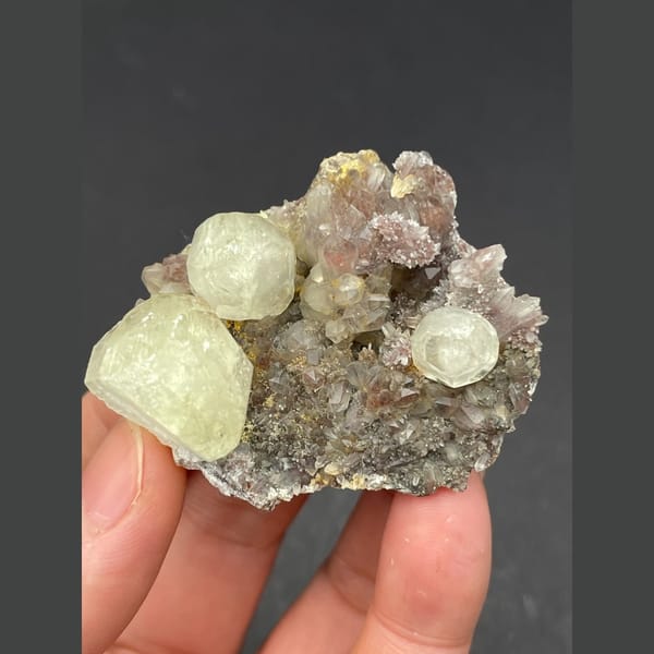 Pale yellow calcite balls on sparkly quartz from Hubei — alternate view