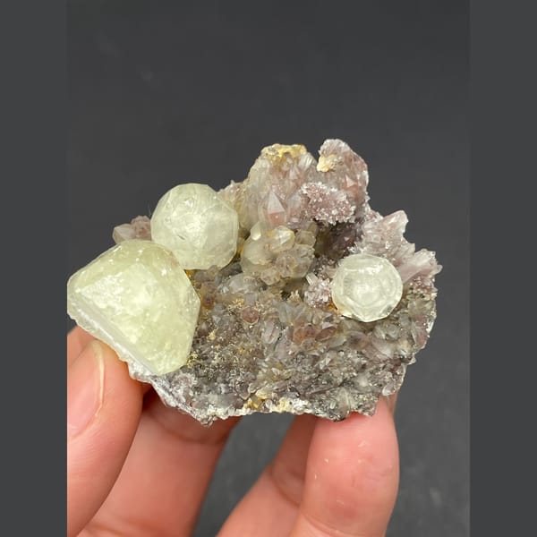 Pale yellow calcite balls on sparkly quartz from Hubei — alternate view