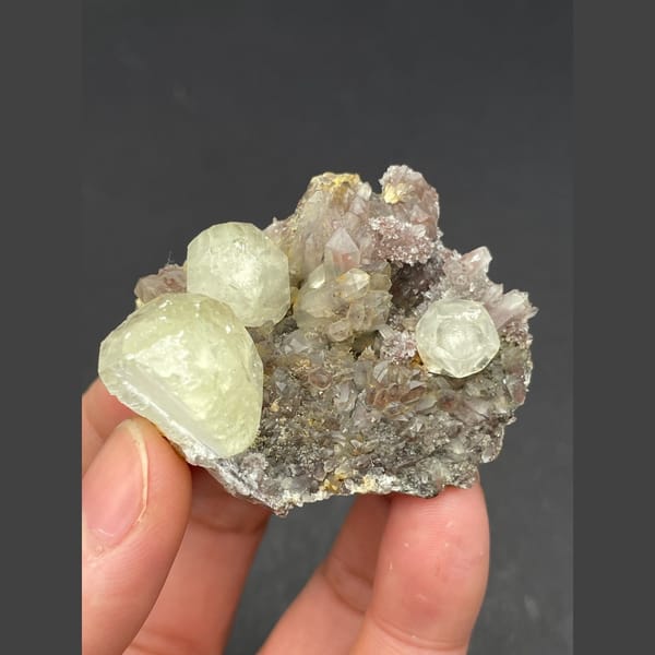 Pale yellow calcite balls on sparkly quartz from Hubei — detail view