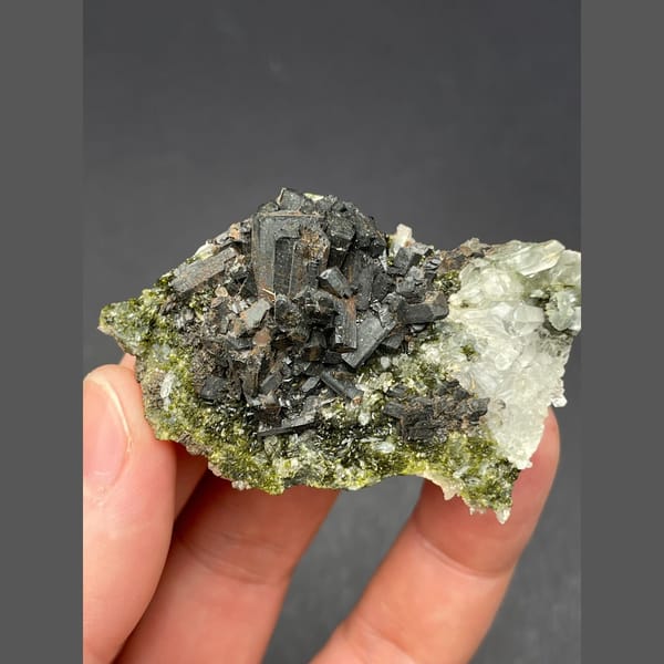 Dark bladed crystals with green epidote and quartz from Zhaotong — alternate view