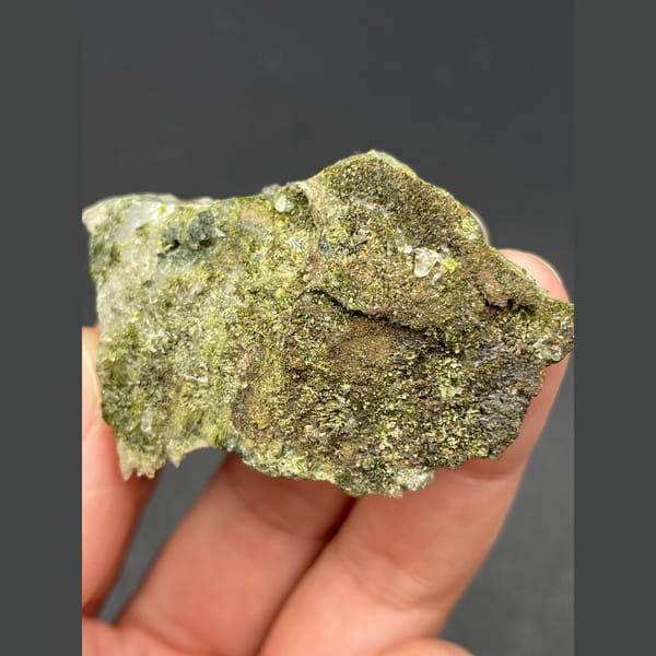 Dark bladed crystals with green epidote and quartz from Zhaotong — detail view