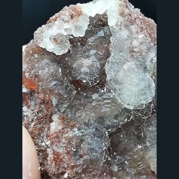 Ball-shaped fluorite on red matrix from Huanggangliang — alternate view