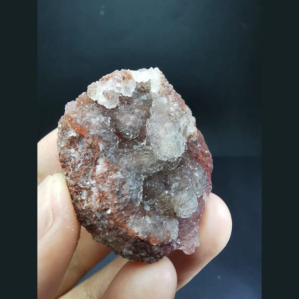 Ball-shaped fluorite on red matrix from Huanggangliang — detail view