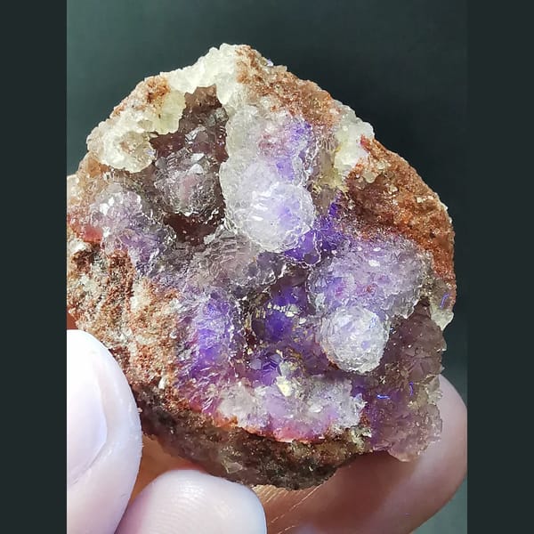 Ball-shaped fluorite on red matrix from Huanggangliang — detail view