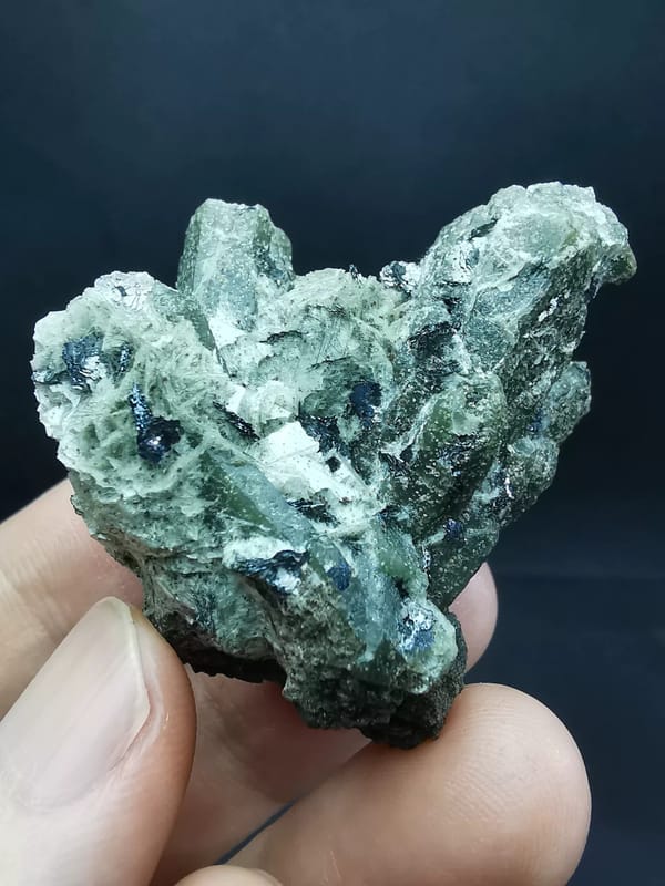 Complete hero view of branching green quartz with hematite and calcite