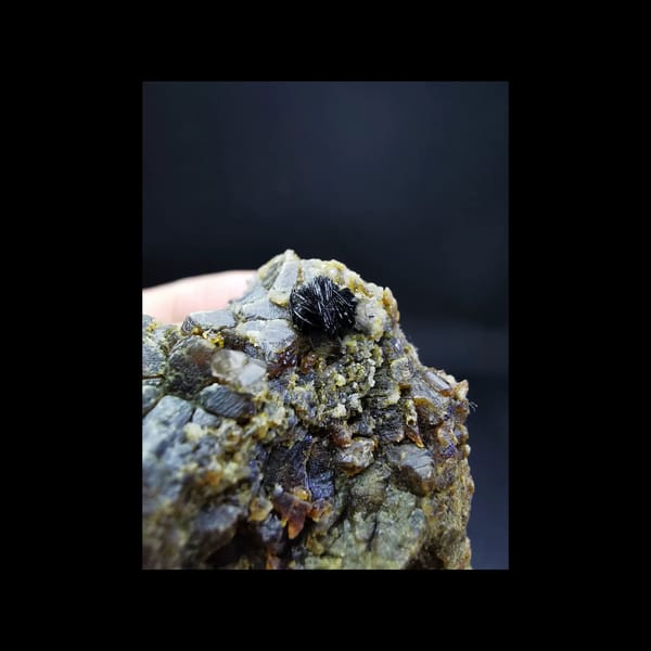 Etched garnet with a specular hematite ball — alternate view