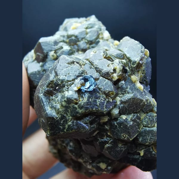 Etched andradite cluster with specular hematite flower — alternate view