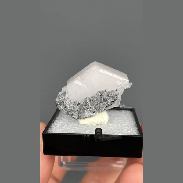 Tabular pale pink calcite in grey matrix from Fujian — complete view