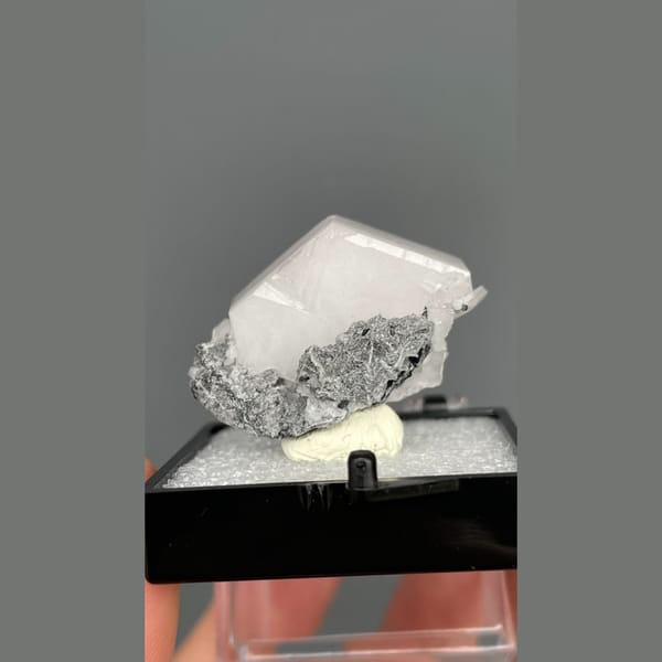 Tabular pale pink calcite in grey matrix from Fujian — detail view