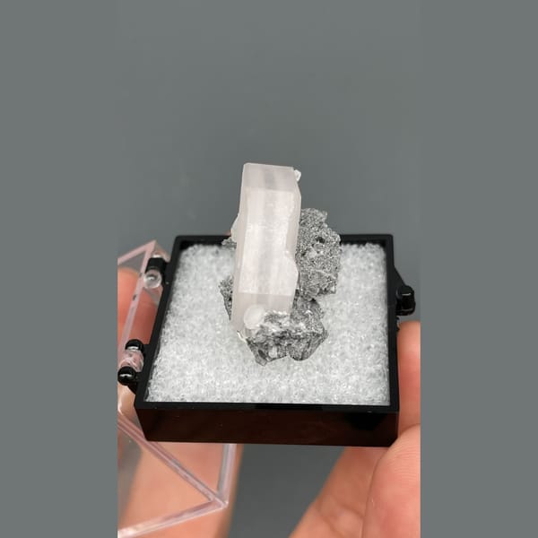 Tabular pale pink calcite in grey matrix from Fujian — detail view