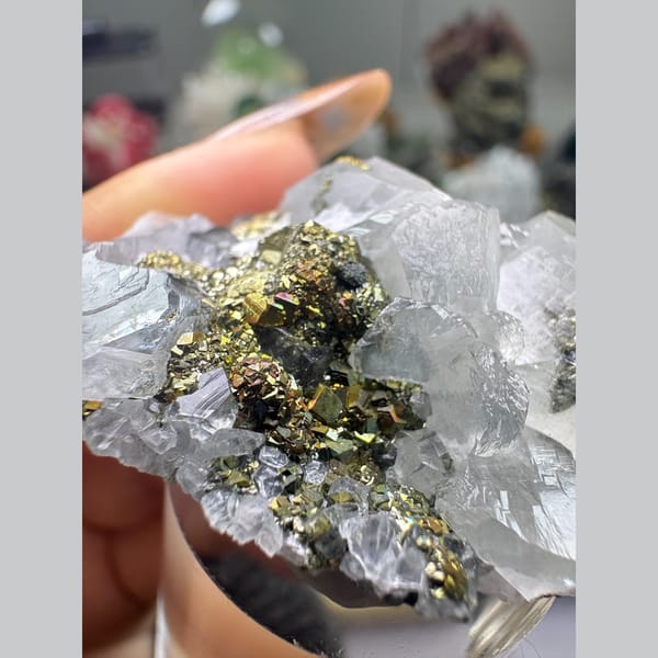 Translucent calcite crystals with brassy pyrite — detail view