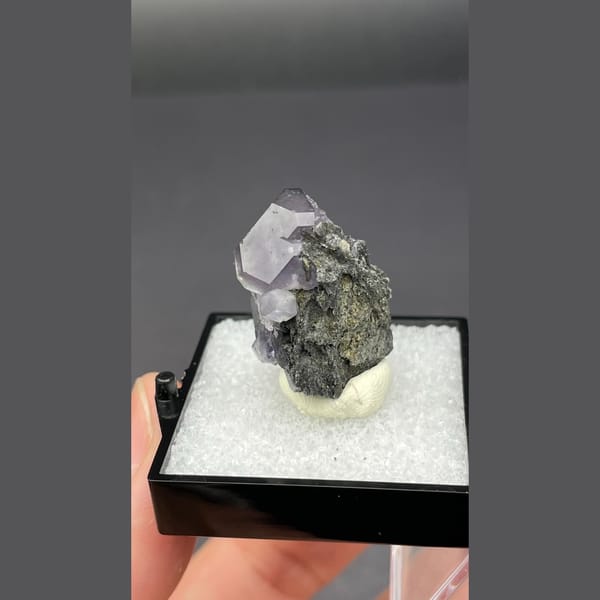 Violet blue fluorite crystal on dark matrix from Fujian — alternate view