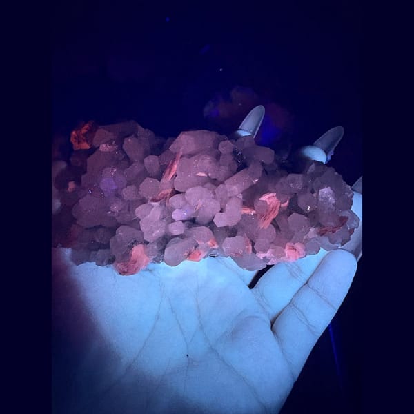Quartz cluster with green chlorite and red calcite rosettes — detail view
