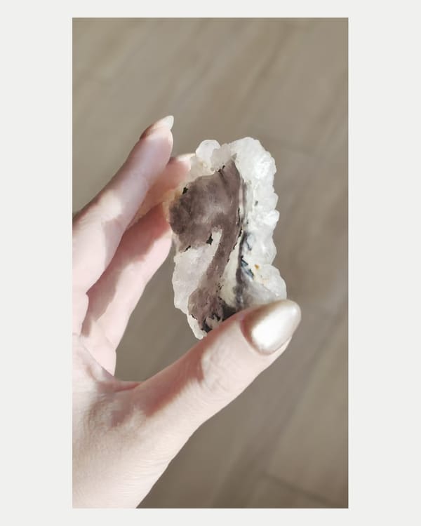 Complete narrow side view of white phantom quartz cluster