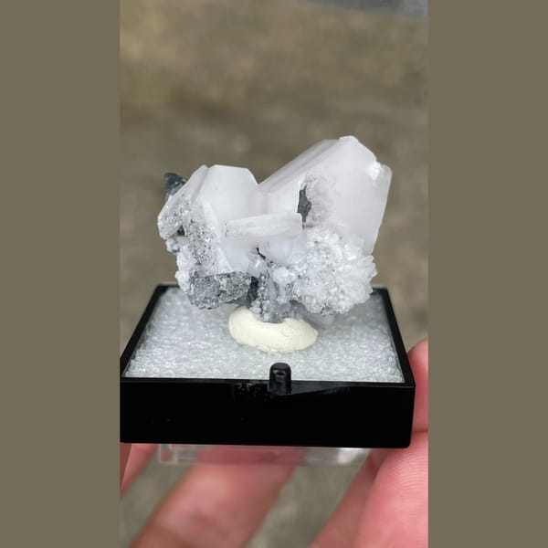 Tabular white calcite with grey matrix from Fujian — complete view