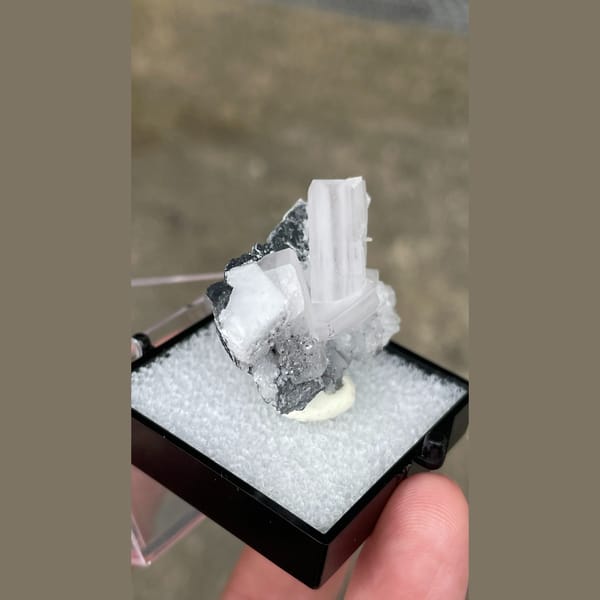 Tabular white calcite with grey matrix from Fujian — alternate view