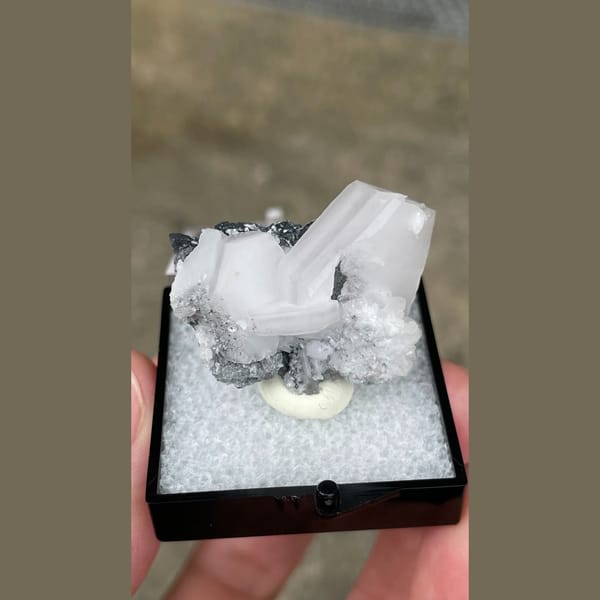 Tabular white calcite with grey matrix from Fujian — alternate view