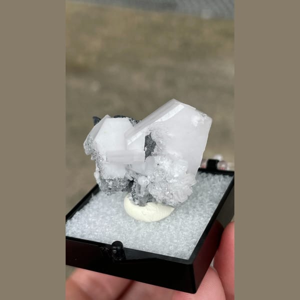 Tabular white calcite with grey matrix from Fujian — detail view