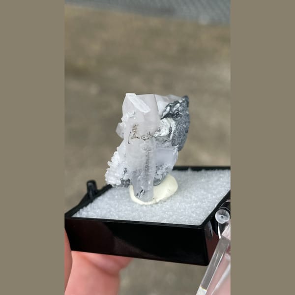 Tabular white calcite with grey matrix from Fujian — detail view