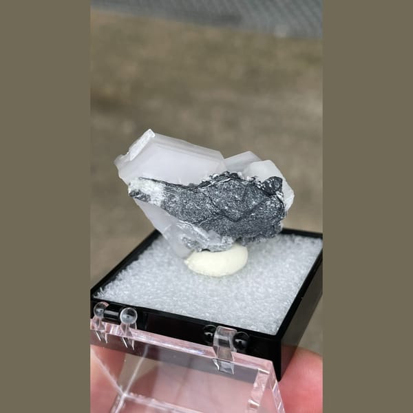 Tabular white calcite with grey matrix from Fujian — detail view