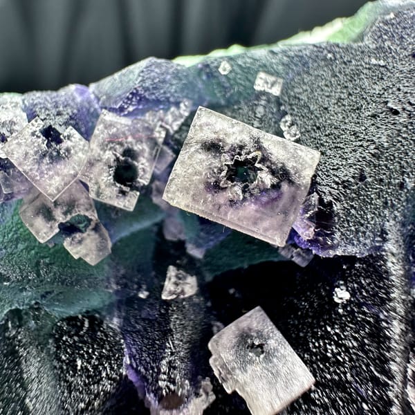 Blue-green-purple octahedral fluorite with white secondary cubes from Zhejiang — alternate view