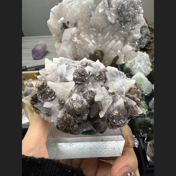 Dogtooth calcite with sugary quartz and a dark mineral — complete view