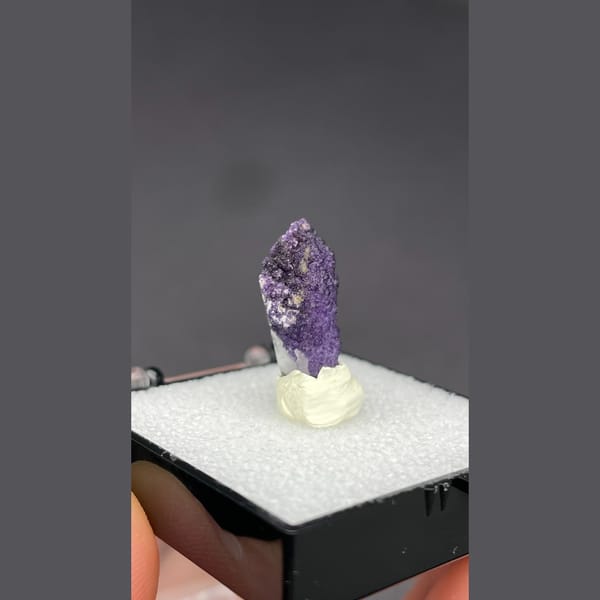 Deep purple fluorite coating a quartz point from Inner Mongolia — complete view