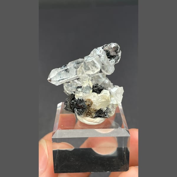 Clear quartz on specular hematite from Guangdong — complete view