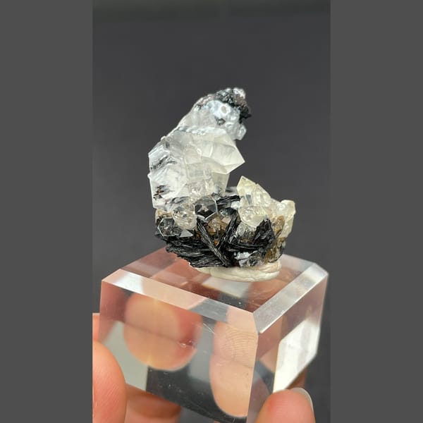 Clear quartz on specular hematite from Guangdong — alternate view