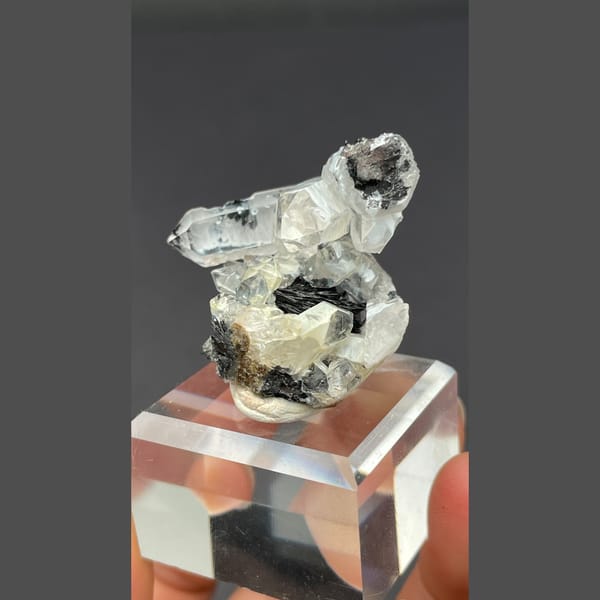 Clear quartz on specular hematite from Guangdong — detail view